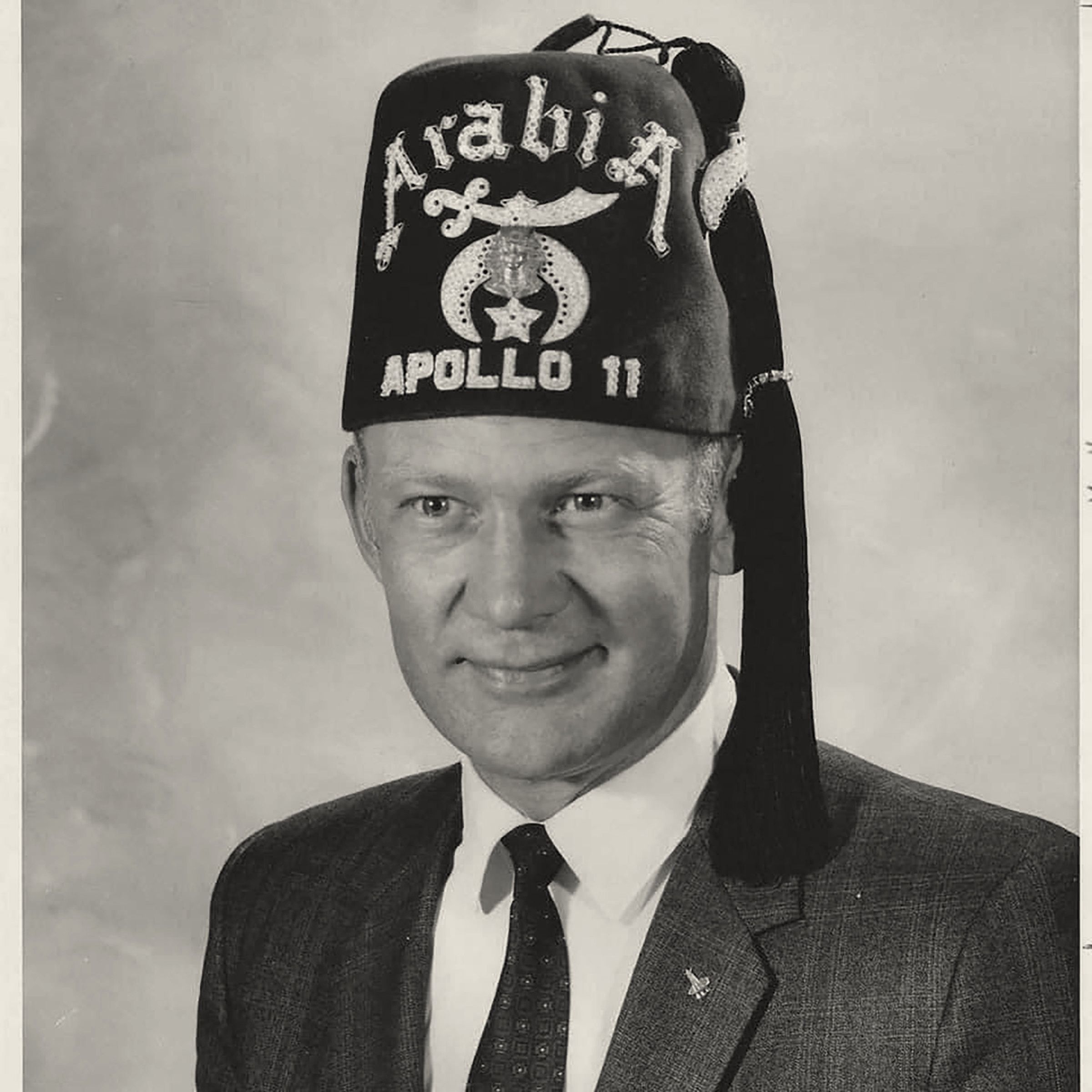Buzz Aldrin smiling in a Shriners fez lettered Arabia, Apollo 11.