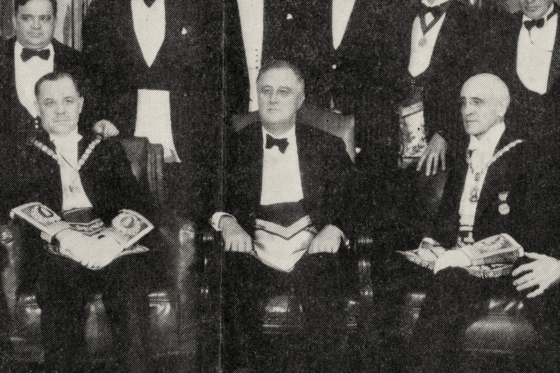 Franklin D. Roosevelt seated between men in Masonic aprons and collars.